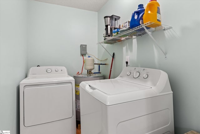 laundry area with washing machine and dryer, laundry area, electric water heater, and a textured ceiling