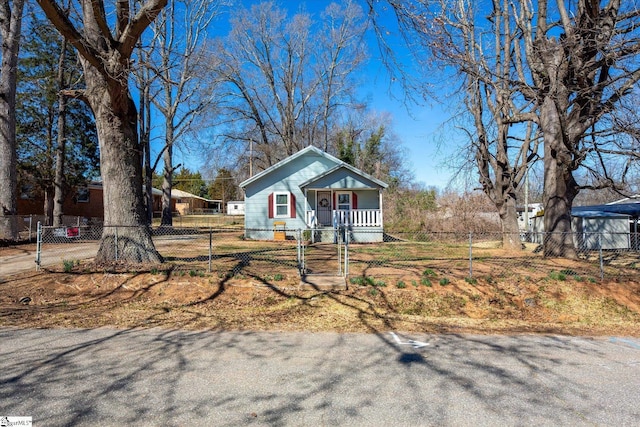 view of front of home with covered porch and a fenced front yard