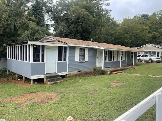 view of front facade with a porch, a front yard, crawl space, and a shingled roof