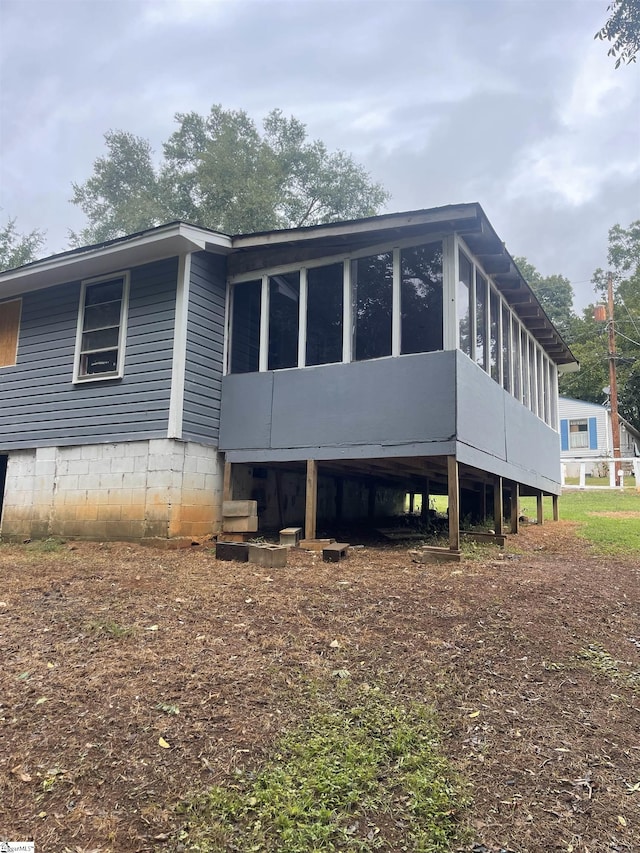 back of house with a sunroom