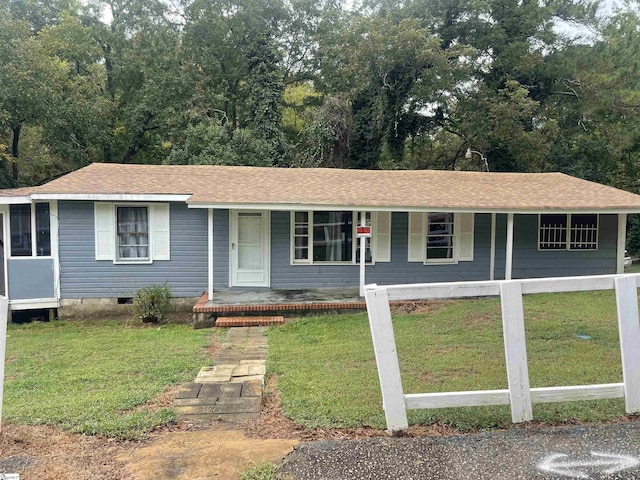 ranch-style house featuring covered porch, a front lawn, crawl space, and a shingled roof