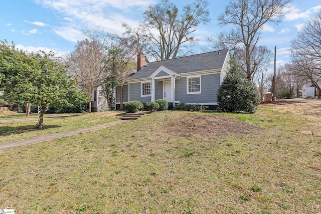 view of front of house featuring a chimney and a front yard