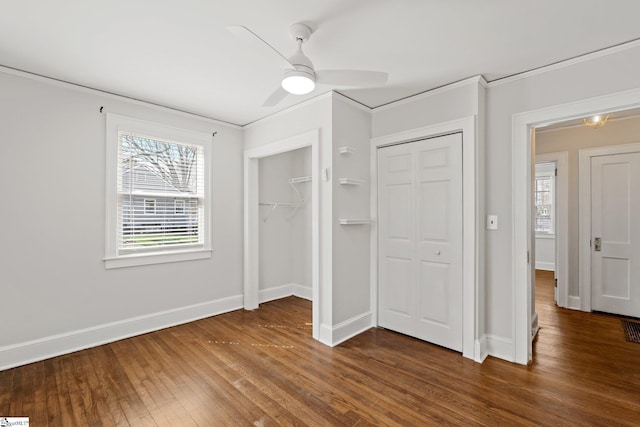 unfurnished bedroom featuring visible vents, dark wood finished floors, baseboards, and ceiling fan