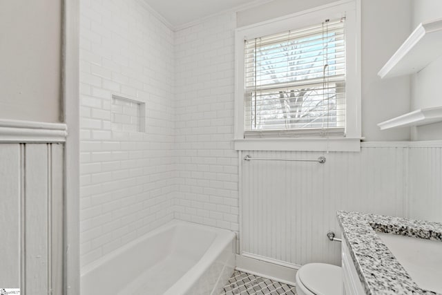 bathroom with toilet, a wainscoted wall, and vanity