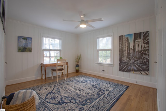 office space with baseboards, wood finished floors, a wealth of natural light, and crown molding