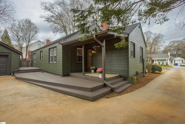 rear view of property featuring a deck and a chimney