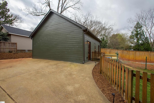 view of side of property featuring a patio and fence