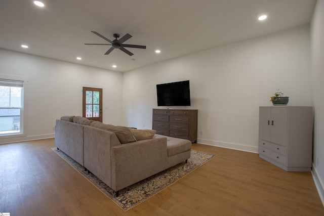 living area featuring ceiling fan, light wood-style flooring, and recessed lighting