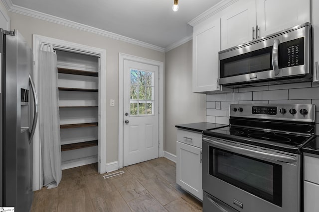 kitchen with stainless steel appliances, dark countertops, ornamental molding, and decorative backsplash