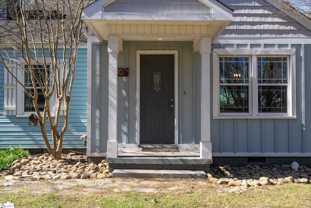 entrance to property featuring crawl space and board and batten siding