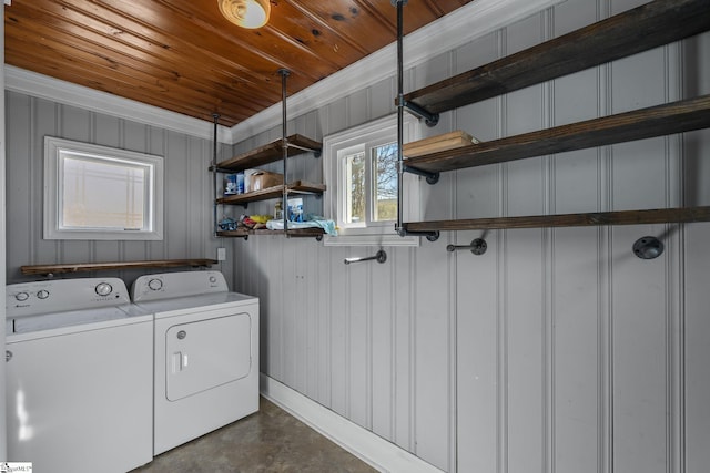 laundry room featuring laundry area, wood ceiling, crown molding, and washer and dryer