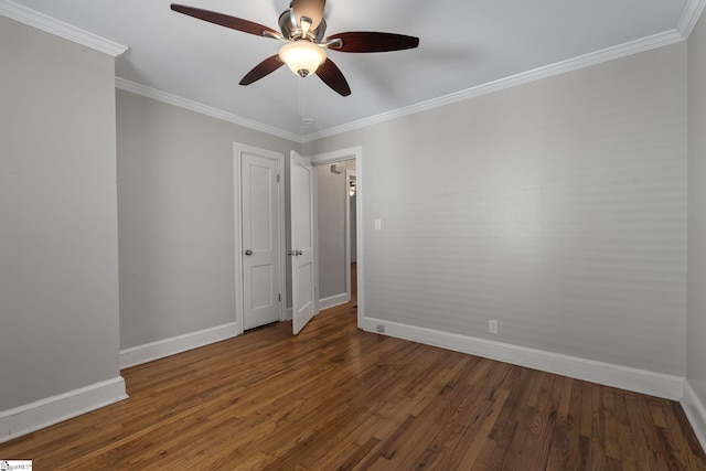 unfurnished room with ornamental molding, wood finished floors, a ceiling fan, and baseboards