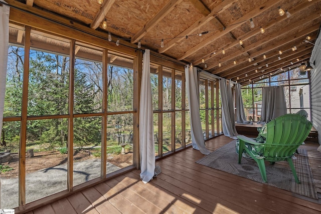 unfurnished sunroom with lofted ceiling