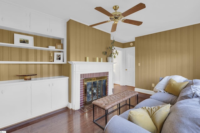 living area with dark wood-style floors, a fireplace, baseboards, and a ceiling fan