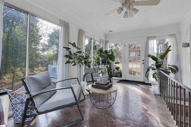 sunroom featuring ceiling fan and a wealth of natural light