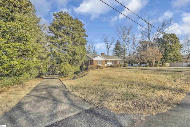 view of front of home with a front yard and a chimney