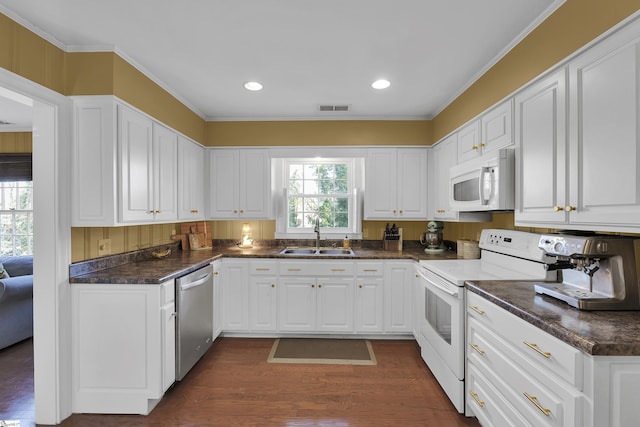 kitchen featuring white appliances, a sink, visible vents, and white cabinets