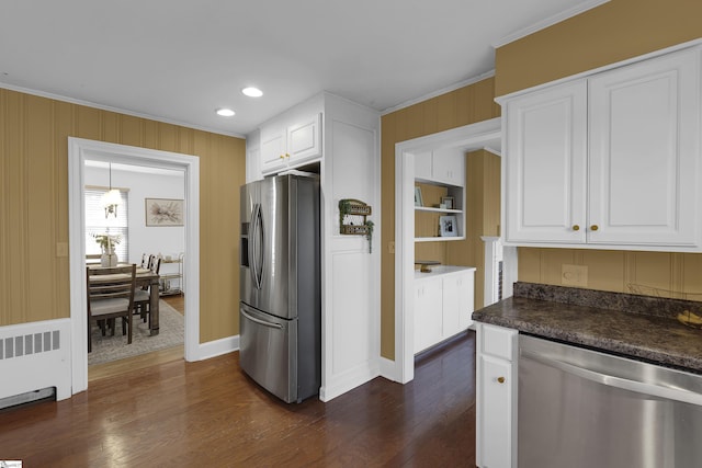 kitchen featuring radiator, appliances with stainless steel finishes, white cabinets, and ornamental molding