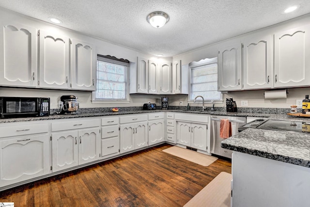 kitchen with a sink, white cabinets, stainless steel dishwasher, a wealth of natural light, and dark wood-style floors