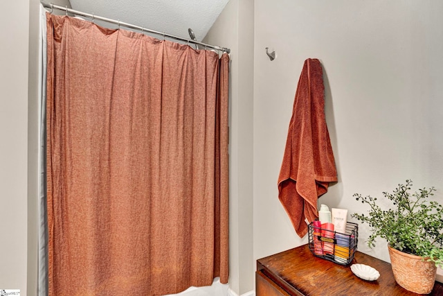 full bath with a textured ceiling