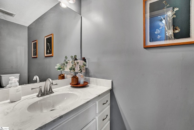 bathroom with visible vents and vanity