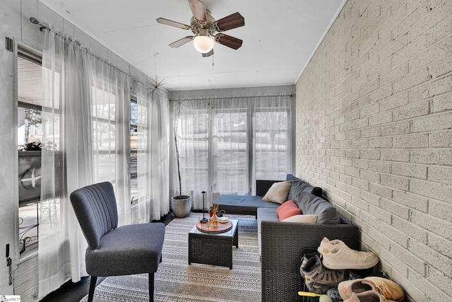 sunroom featuring a ceiling fan