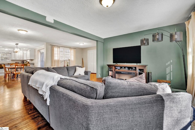 living room featuring a textured ceiling and wood finished floors