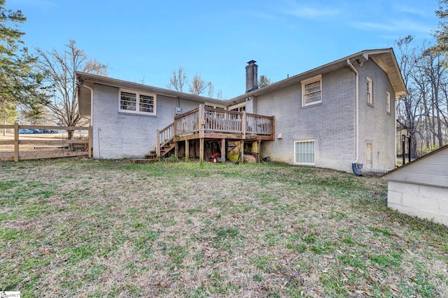 back of house with brick siding, a chimney, stairway, fence, and a wooden deck