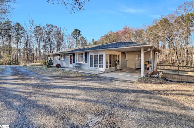 view of front of home featuring roof with shingles and fence