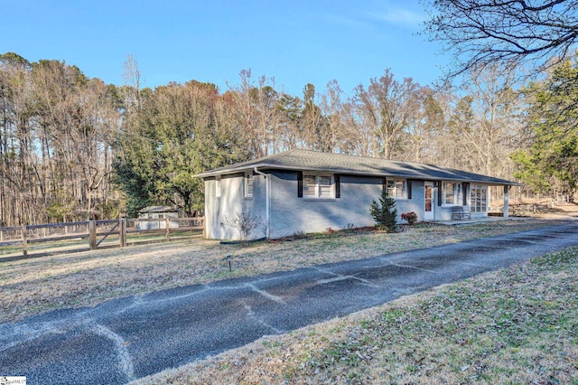 view of front of home with brick siding and fence