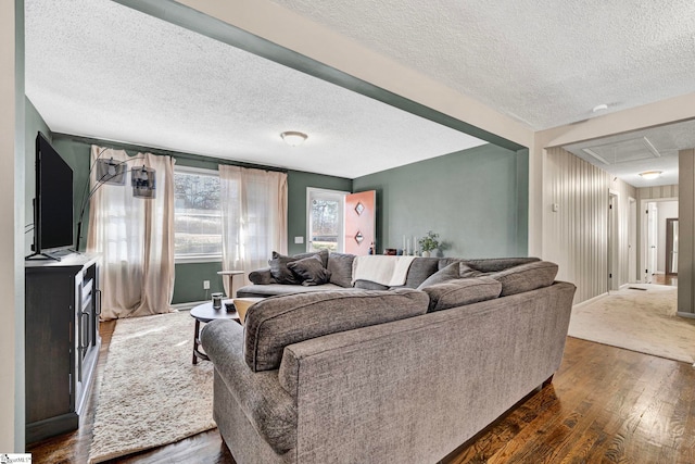 living area with a textured ceiling and dark wood-type flooring