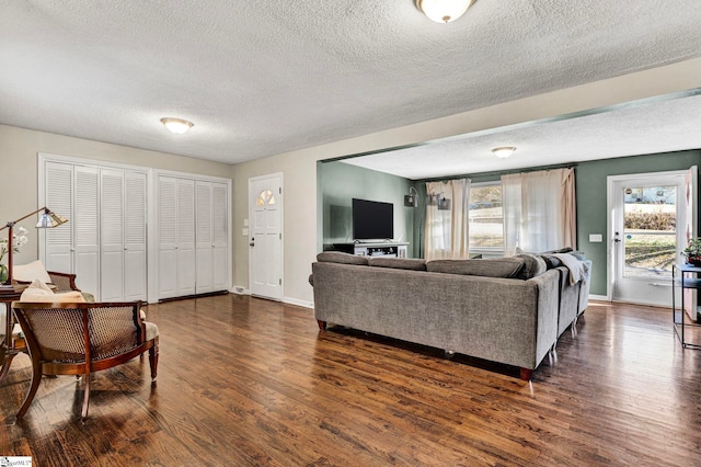 living room with a wealth of natural light, dark wood-style flooring, and baseboards