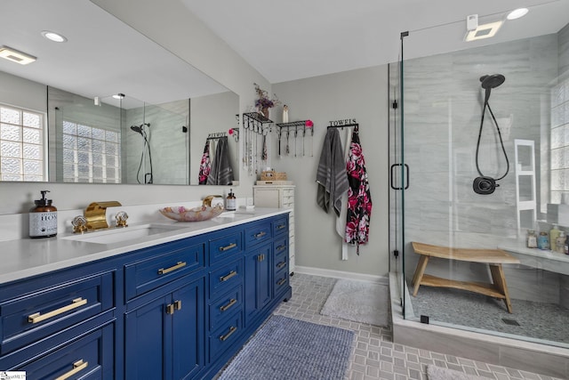 full bath featuring double vanity, a stall shower, a sink, and visible vents