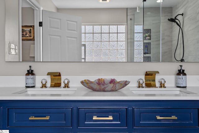 bathroom featuring a tile shower, a sink, and double vanity