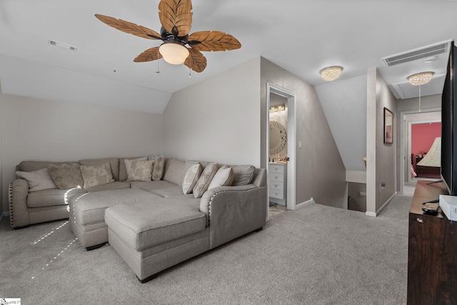 carpeted living room with attic access, visible vents, vaulted ceiling, and baseboards