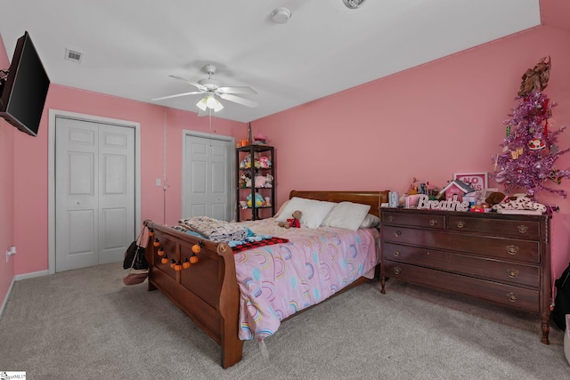 carpeted bedroom featuring visible vents and a ceiling fan