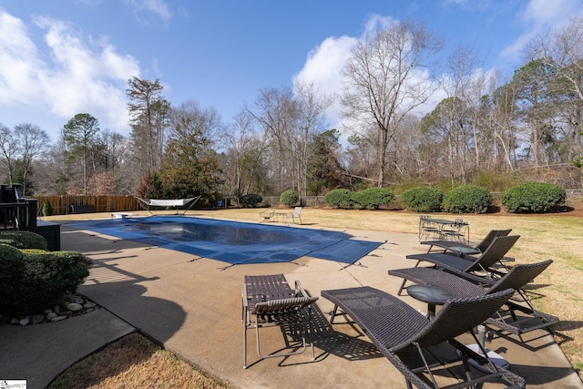 view of swimming pool with a diving board, a patio area, fence, and a fenced in pool