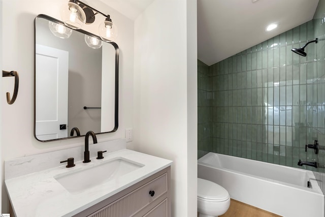 bathroom featuring vanity, toilet, and shower / bathtub combination