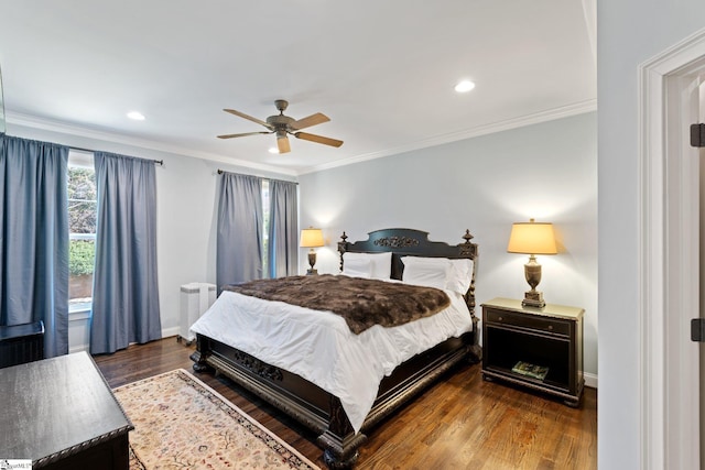 bedroom featuring baseboards, crown molding, radiator heating unit, and wood finished floors