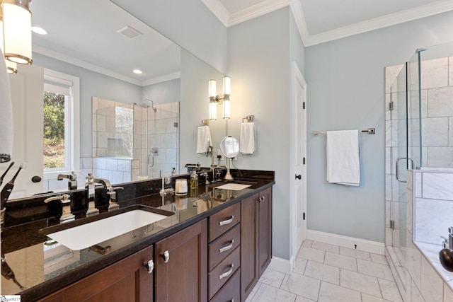 bathroom with a stall shower, baseboards, ornamental molding, and a sink