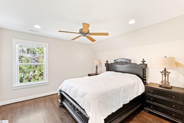 bedroom with baseboards, visible vents, lofted ceiling, dark wood-style floors, and recessed lighting