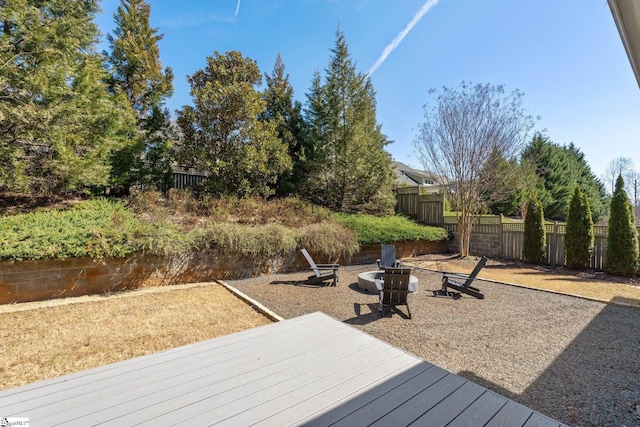 wooden terrace with fence and a fire pit