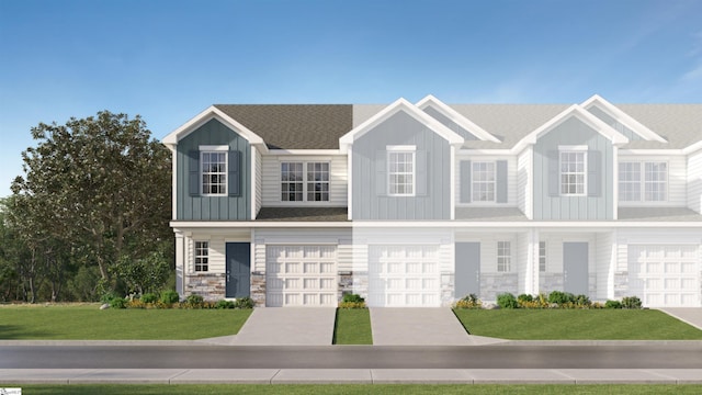 view of front of home featuring a garage, stone siding, concrete driveway, board and batten siding, and a front yard