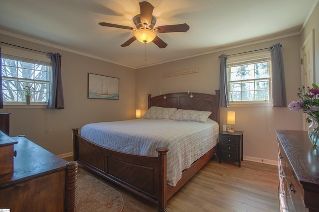 bedroom featuring baseboards, ceiling fan, wood finished floors, and crown molding