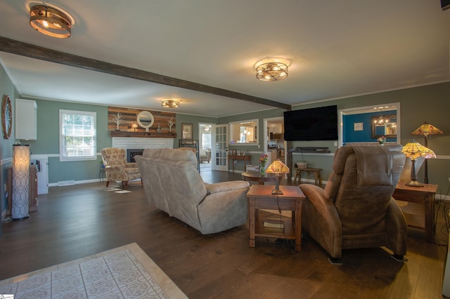 living room with a large fireplace, crown molding, beam ceiling, and wood finished floors