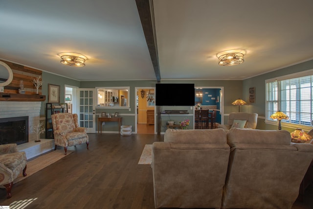 living room with ornamental molding, a fireplace, and wood finished floors