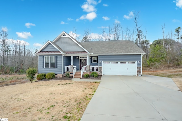 view of front facade featuring a garage, concrete driveway, metal roof, crawl space, and covered porch