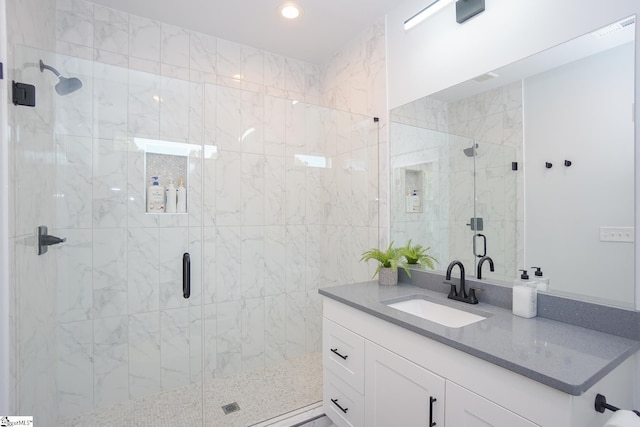 bathroom with a stall shower, vanity, visible vents, and recessed lighting