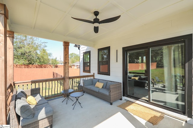 exterior space featuring fence, an outdoor hangout area, and a ceiling fan