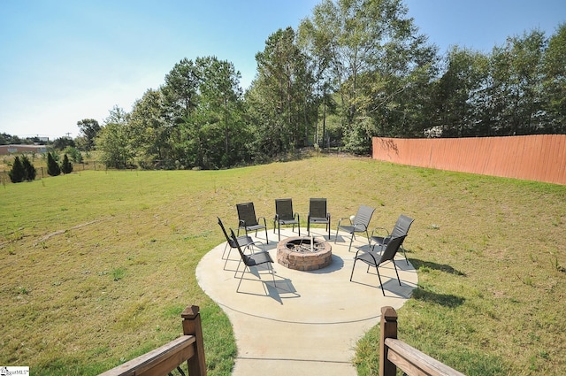 view of yard featuring a patio area, an outdoor fire pit, and fence